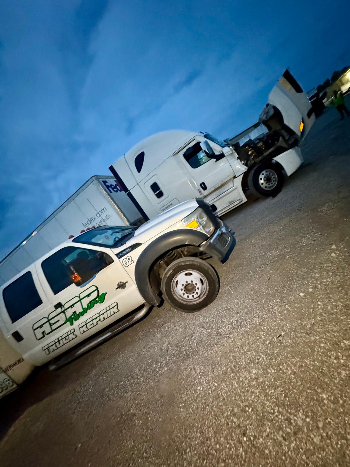 Diesel mechanic repairing semi truck engine near Chattanooga